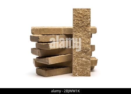 Decorative facing bricks for fence or wall on white background. Brick with rocky relief surface. Stock Photo