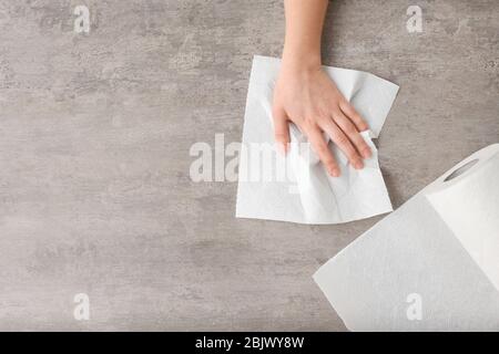 Woman wiping table with paper towel Stock Photo