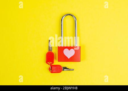 Red lock with drawing heart and key on yallow background Stock Photo