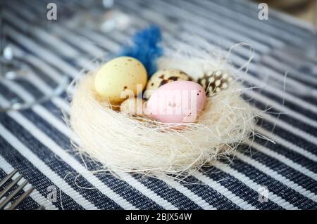 Decorative nest with quail eggs for Easter table setting Stock Photo