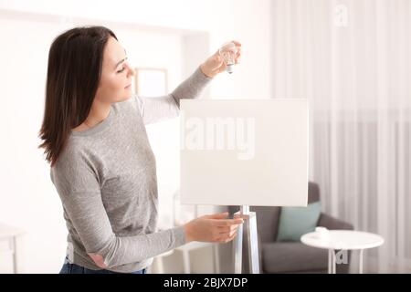 Woman changing light bulb in lamp at home Stock Photo