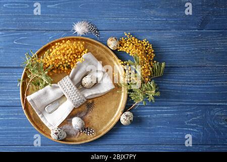 Beautiful festive Easter table setting with mimosa and quail eggs Stock Photo