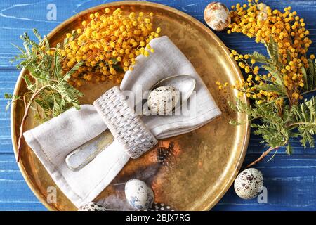 Beautiful festive Easter table setting with mimosa and quail eggs Stock Photo