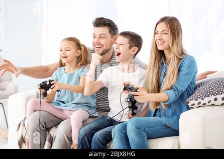 Happy family playing video games at home Stock Photo