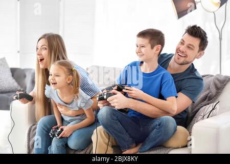 Happy family playing video games at home Stock Photo