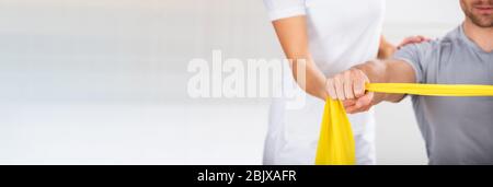 Band Resistance Physical Shoulder Exercise With Therapist Stock Photo