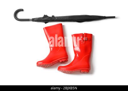 Black umbrella and gumboots on white background Stock Photo
