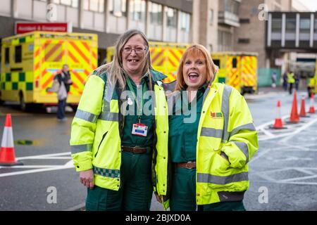 Addenbrookes Hospital Cambridge, UK. 30th Apr, 2020. Two Ambulance Staff outside the Accident and Emergency Department during the clap to thank staff for their work during the Covid 19 coronavirus outbreak. The Magpas Air Ambulance flew over the hospital as a mark of respect. Credit: Julian Eales/Alamy Live News Stock Photo