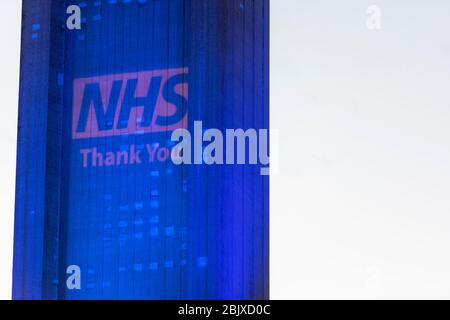 Addenbrookes Hospital Cambridge, UK. 30th Apr, 2020. A tower is lit up in blue with a thanks NHS sign to thank staff for their work during the Covid 19 coronavirus outbreak. The Magpas Air Ambulance flew over the hospital as a mark of respect. Credit: Julian Eales/Alamy Live News Stock Photo