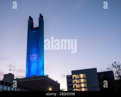 Addenbrookes Hospital Cambridge, UK. 30th Apr, 2020. A tower is lit up in blue with a thanks NHS sign to thank staff for their work during the Covid 19 coronavirus outbreak. The Magpas Air Ambulance flew over the hospital as a mark of respect. Credit: Julian Eales/Alamy Live News Stock Photo