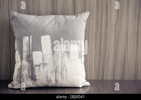 Stylish soft pillow on table Stock Photo