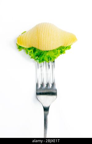 Conchiglie pasta with lettuce on a fork isolated against white Stock Photo