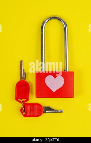 Red lock with drawing heart and key on yallow background Stock Photo