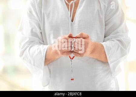 Senior Muslim man holding beads, closeup Stock Photo