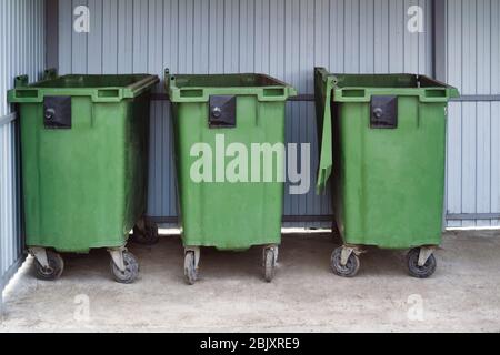 Green garbage containers. Disposal during a pandemic. Sanitary standards. Stock Photo