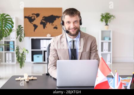 Male travel agent in office Stock Photo