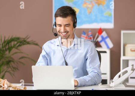 Male travel agent working in office Stock Photo