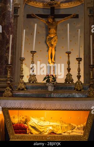 Marvelous 15th century wooden Crucifix created by the school of Donatello inside the San Donata Catholic church dating from 8th century in tiny cliffs Stock Photo