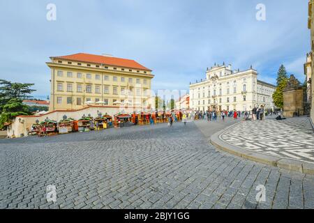 Sellers and vendors sell gifts and souvenirs from outdoor booths at a traditional marketplace on the Castle Hill Complex in Prague, Czechia. Stock Photo