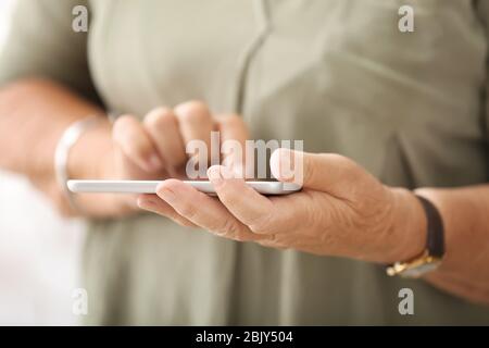 Elderly woman with modern tablet computer, closeup Stock Photo