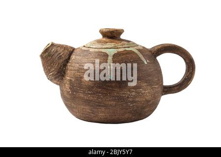 Handmade clay teapot Isolated on a white background. Antique pottery. Close-up. Stock Photo