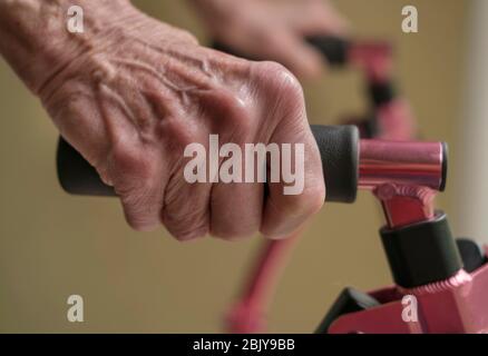 Close up of hands of senior woman on mobility walker Stock Photo