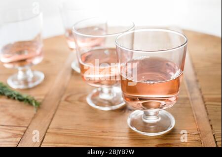 Glasses of rose wine on wooden table Stock Photo