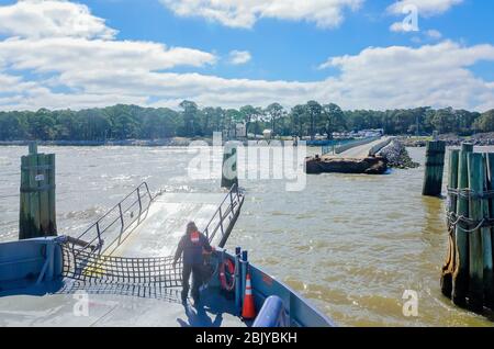 A worker prepares the Mobile Bay Ferry to dock at the Fort Morgan ferry landing, March 4, 2016, in Gulf Shores, Alabama. Stock Photo