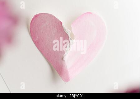 Ripped paper in the shape of a heart against a red background Stock ...