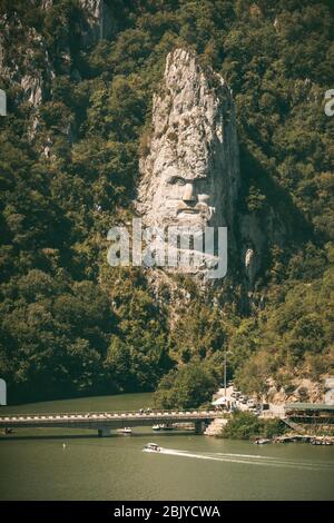 Decebalus sculpture in Romania - seen from Serbia accross Danube River. Orsova, Romania. Stock Photo