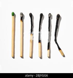 Row of burnt matchsticks on white background Stock Photo