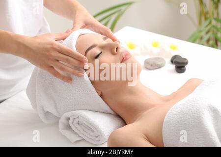 Young woman having facial massage in beauty salon Stock Photo