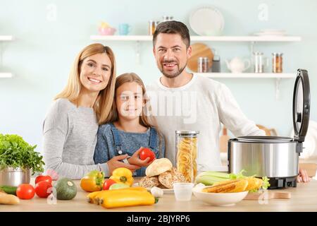 Happy family with modern multi cooker in kitchen Stock Photo