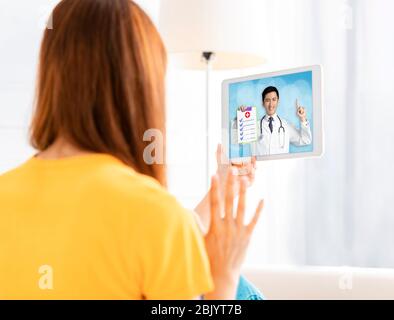 young woman  Video chatting With Doctor On digital tablet Stock Photo