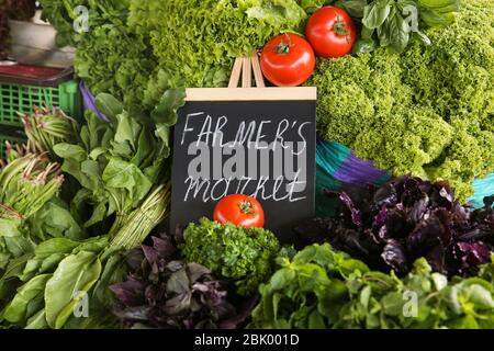 Assortment of fresh herbs on counter at farmer's market Stock Photo