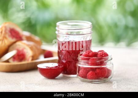 Tasty raspberry jam with berries on table Stock Photo