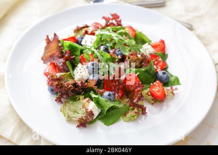 Plate with fresh tasty salad on table, closeup Stock Photo