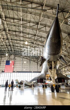 A family gazes up at the B1 Lancer exhibited at the Wings Over the Rockies museum in Denver, Colorado, USA. Stock Photo