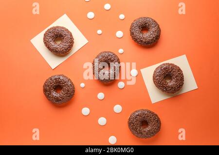 Sweet tasty donuts on color background Stock Photo
