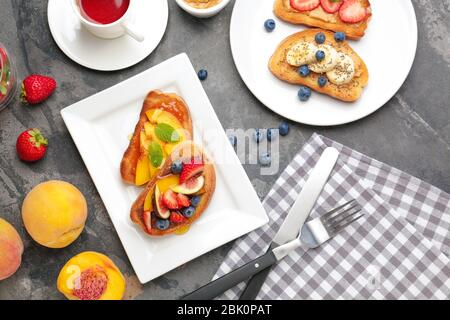 Plate with tasty sandwiches and cup of tea on table Stock Photo