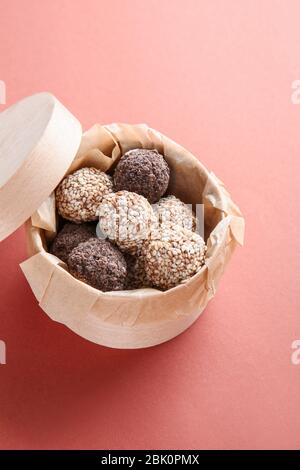 Box with tasty sweet truffles on color background Stock Photo