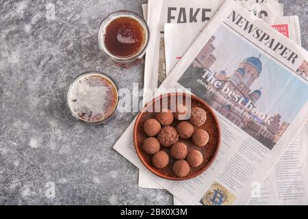 Plate with tasty sweet truffles and drink on grey background Stock Photo