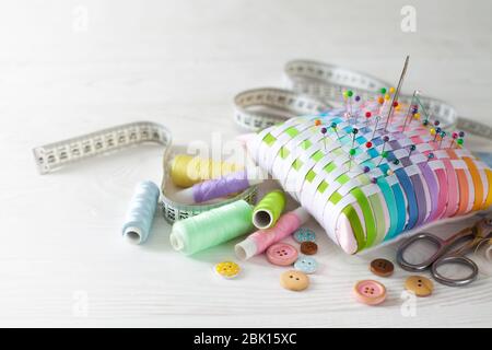 Needle box, threads and cotton fabrics for sewing. White background. Stock Photo