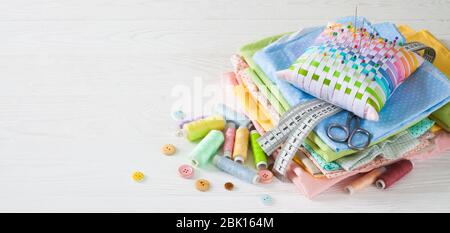 Needle box, threads and cotton fabrics for sewing. White background. Stock Photo