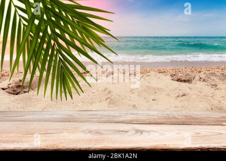 Pattern with wooden boards on a background of sandy beach and sea. Stock Photo