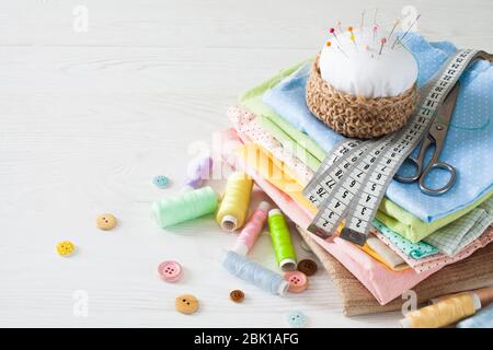 Needle box, threads and cotton fabrics for sewing. White background. Stock Photo