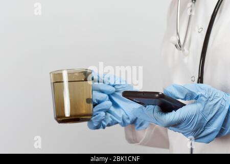 Female doctor using mobile phone during the break. Browsing internet, checking news, email and chat messages Stock Photo