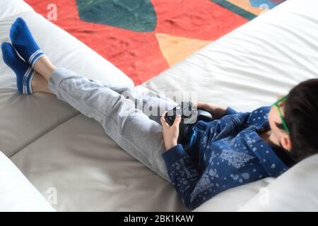 Young caucasian boy playing a video game at home Stock Photo