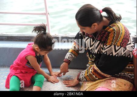 Nathdwara, Rajasthan, India, Asia - Jan. 23, 2014 - Indian happy mother with little girl playing traveling by boat Stock Photo
