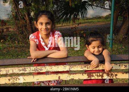 Nathdwara, Rajasthan, India, Asia - Jan. 23, 2014 - Indian happy little cute girls playing in the garden Stock Photo